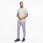 Man wearing a  Men's Pique T-Shirt in color Fog Green with gray pants