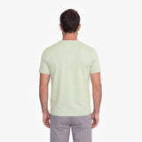 Man wearing a light green t-shirt on a white background