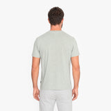 Man wearing a light green t-shirt on a white background