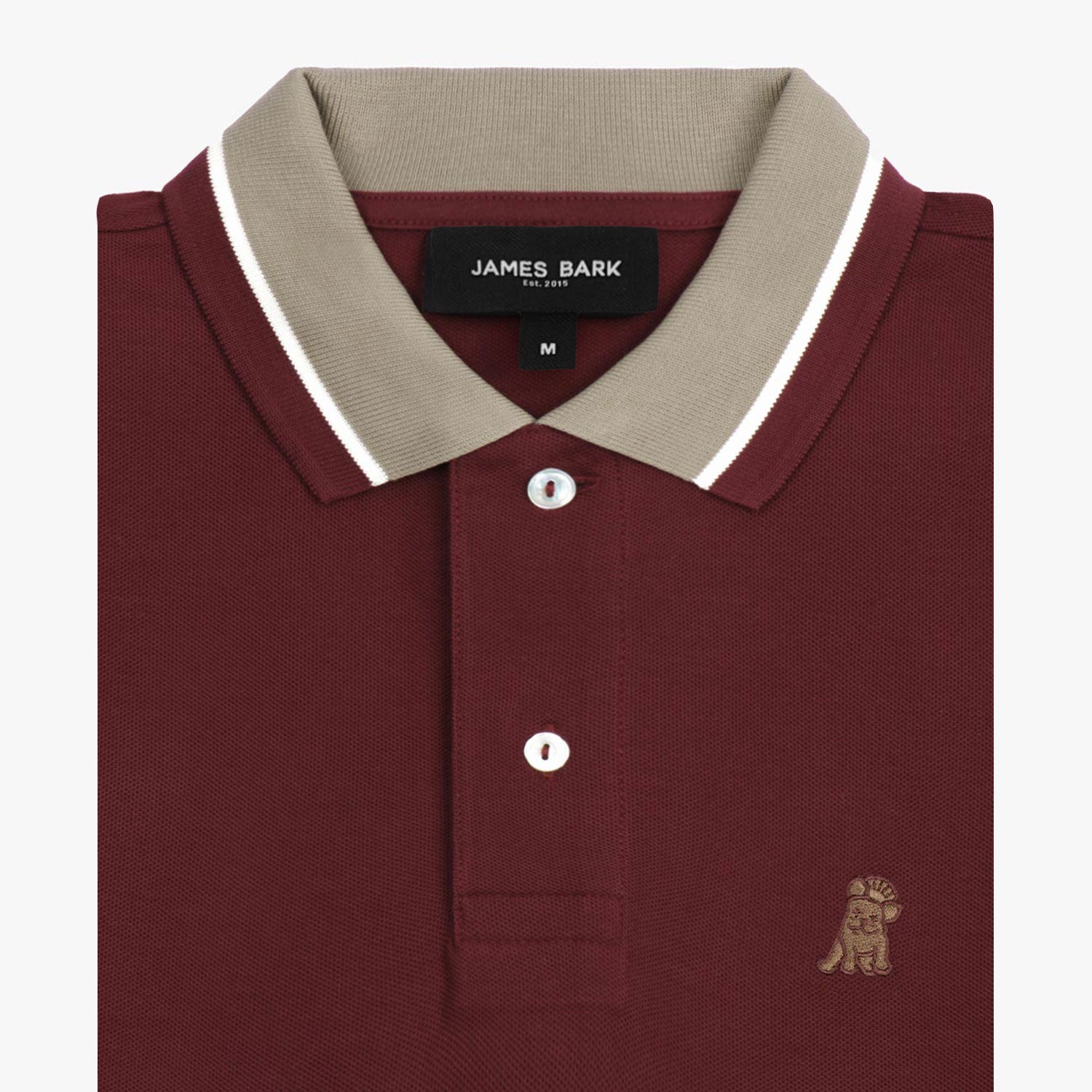 Close-up of the collar and buttons of the maroon polo shirt: A detailed view of the beige collar with white piping, showing the button placket and the small embroidered dog logo on the chest.