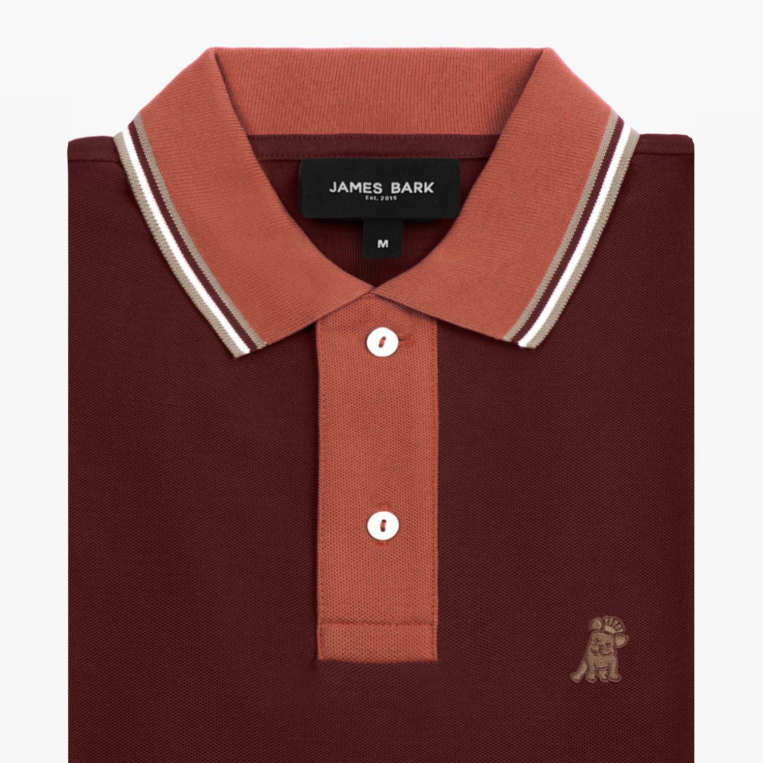 Close-up of the collar and upper part of the burgundy polo shirt, showing the buttons and the small golden embroidered logo on the chest.