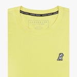 Close-up of the light yellow t-shirt showing the crew neckline and a small embroidered animal logo on the left chest.