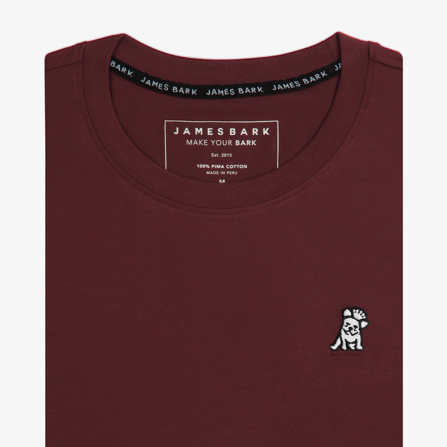 A close-up of the neckline and top of the maroon t-shirt, showing the collar and inner label.