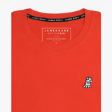 The orange t-shirt laid flat, showing the front of the shirt with the small embroidered animal logo on the left chest.