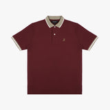 Flat-lay of the maroon polo shirt: The shirt is laid flat, showcasing the front design with a beige collar, sleeve cuffs, and button placket, along with the small embroidered logo on the chest.