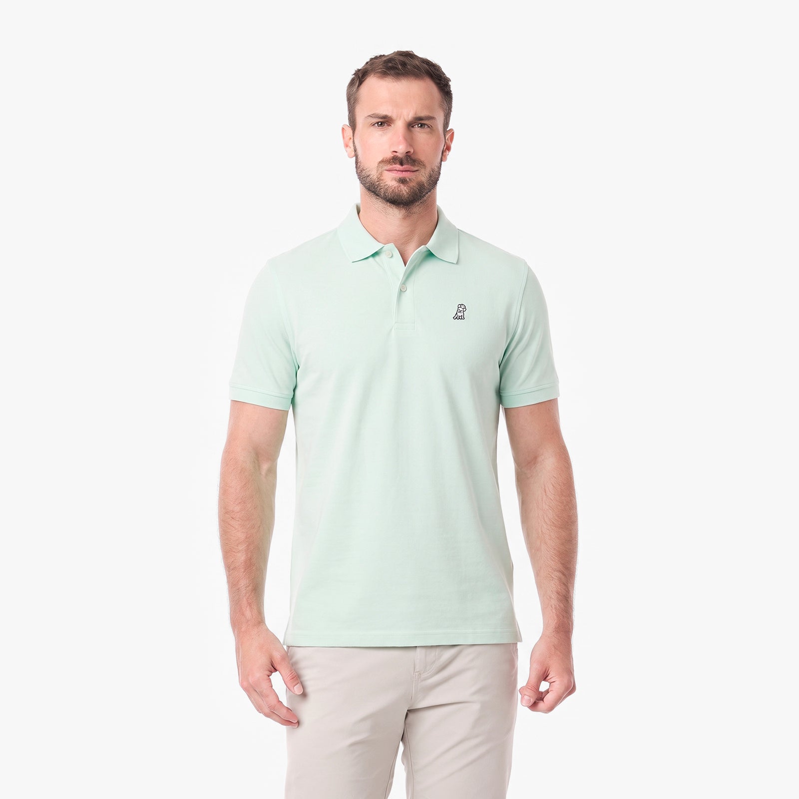 A man wearing a light mint green short-sleeve polo shirt with a small embroidered logo on the left chest