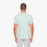 Man wearing a light green t-shirt on a white background