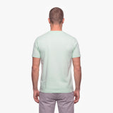 Man wearing a light green t-shirt on a white background