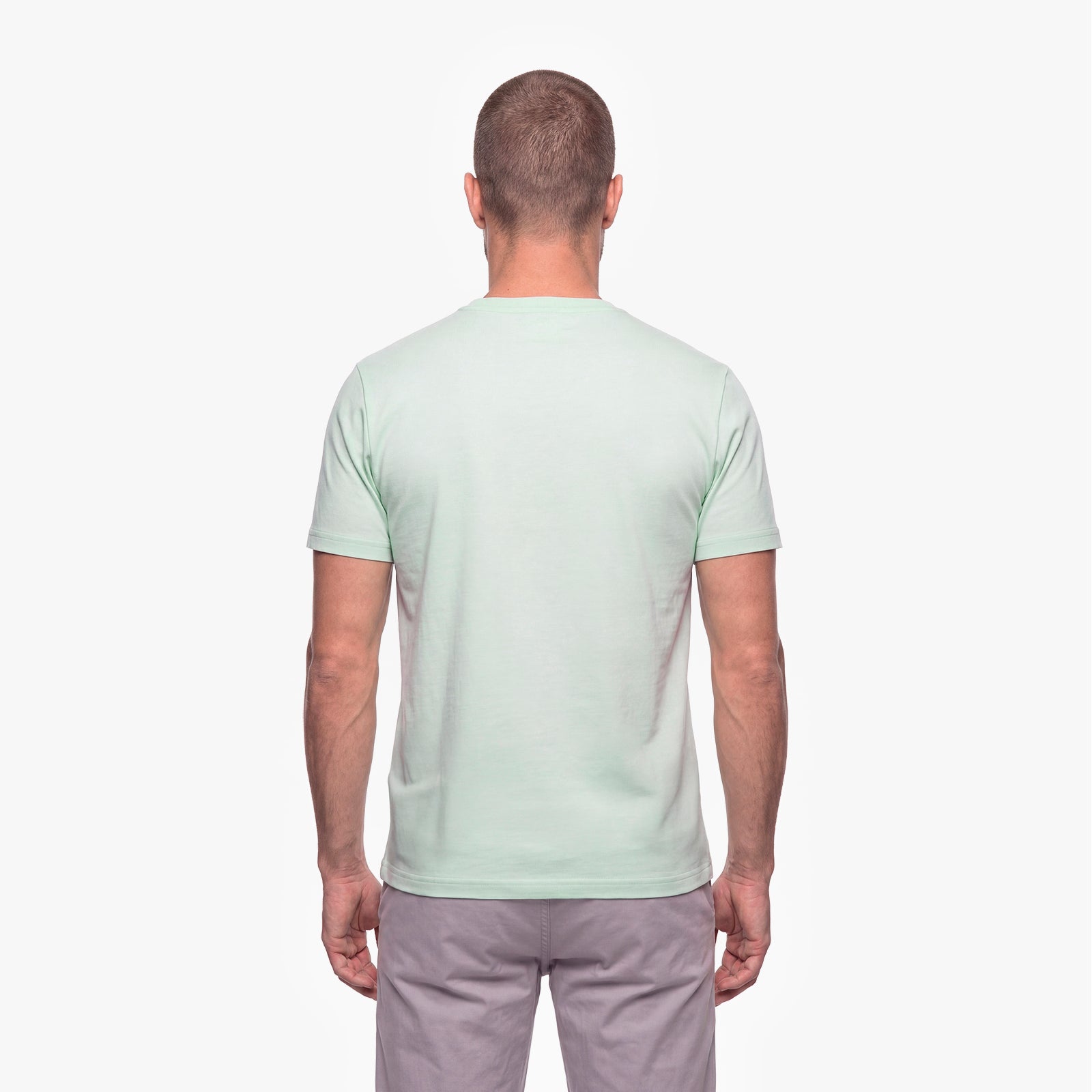 Man wearing a light green t-shirt on a white background