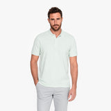 Man wearing a light green polo on a white background