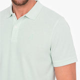 Light green polo shirt with a small logo on a white background