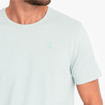Light green t-shirt with a small green logo on a white background