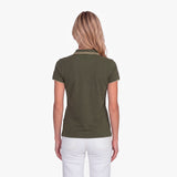 Back view of a woman wearing a green polo with an embroidered dog logo on a white background