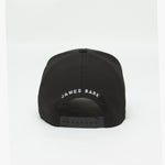 Rear view of the black cap displaying "JAMES BARK" text embroidered in white