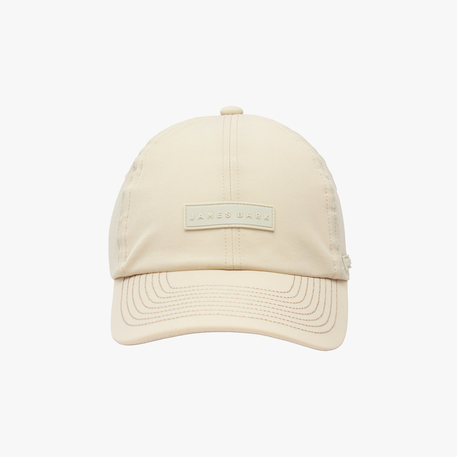 Front view of a beige James Bark baseball cap with a rectangular logo patch on the center