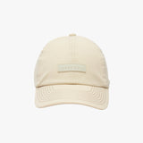 Front view of a beige James Bark baseball cap with a rectangular logo patch on the center