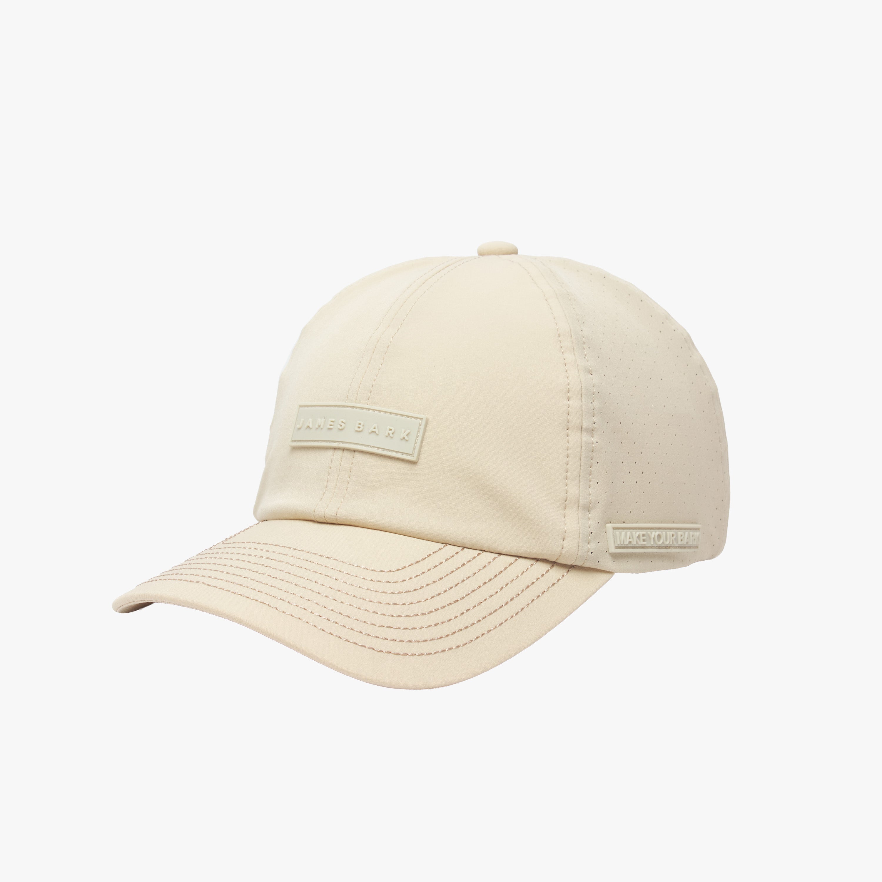 Side view of the beige cap, highlighting the perforated side panels and a small label that reads "MAKE YOUR BARK."
