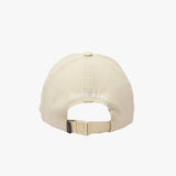 Rear view of the beige cap displaying "JAMES BARK" text in white