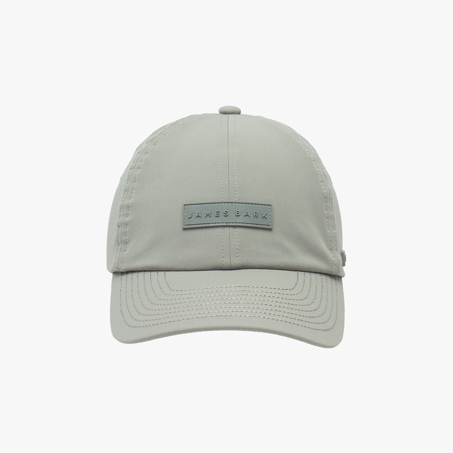 Light grey baseball cap by James Bark, with a rectangular rubberized logo patch