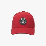 Front view of a red James Bark baseball cap featuring a circular black and white rubberized patch