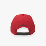 Rear view of the red cap displaying "JAMES BARK" text in black