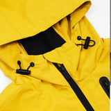 Close-up of the hood section of a yellow James Bark jacket. The hood features adjustable black drawstrings with toggles, a black zipper, and a black inner lining for added contrast and functionality.