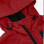 View of the red jacket with the hood and raised collar, showing structure and design.
