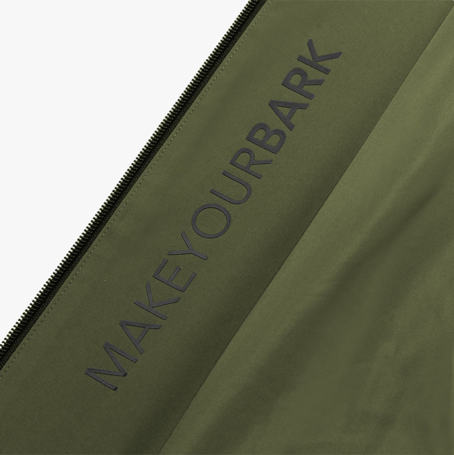 Detail of the “MAKEYOURBARK” text printed on the green jacket.