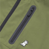 Close-up of the side pocket zipper on the green jacket with the James Bark logo.