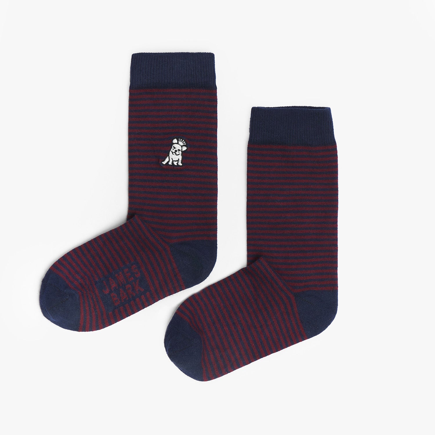 A pair of dark red and navy blue striped mid-calf socks with a solid navy cuff, heel, and toe. There is a small dog graphic in white near the ankle and the text 'JAMES BARK' printed in navy near the toe. The socks are laid flat on a white surface.