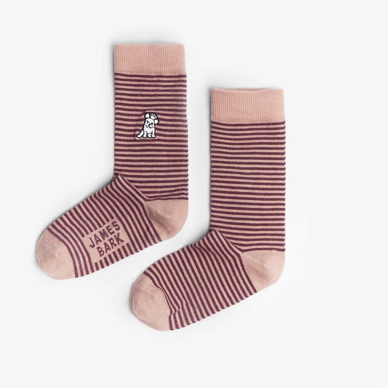 A pair of brown and pink striped mid-calf socks with a solid pink cuff, heel, and toe. There is a small dog graphic near the ankle and the text 'JAMES BARK' printed near the toe. The socks are laid flat on a white surface.