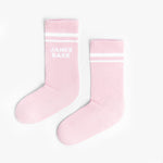 A pair of pink mid-calf socks with two white stripes at the top and the text 'JAMES BARK' printed in white near the ankle. The socks are laid flat on a white surface.