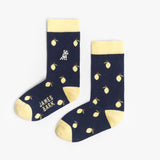 A pair of navy blue mid-calf socks with a yellow cuff, heel, and toe, featuring a lemon pattern and the text 'JAMES BARK' printed in yellow near the ankle. The socks are laid flat on a white surface.