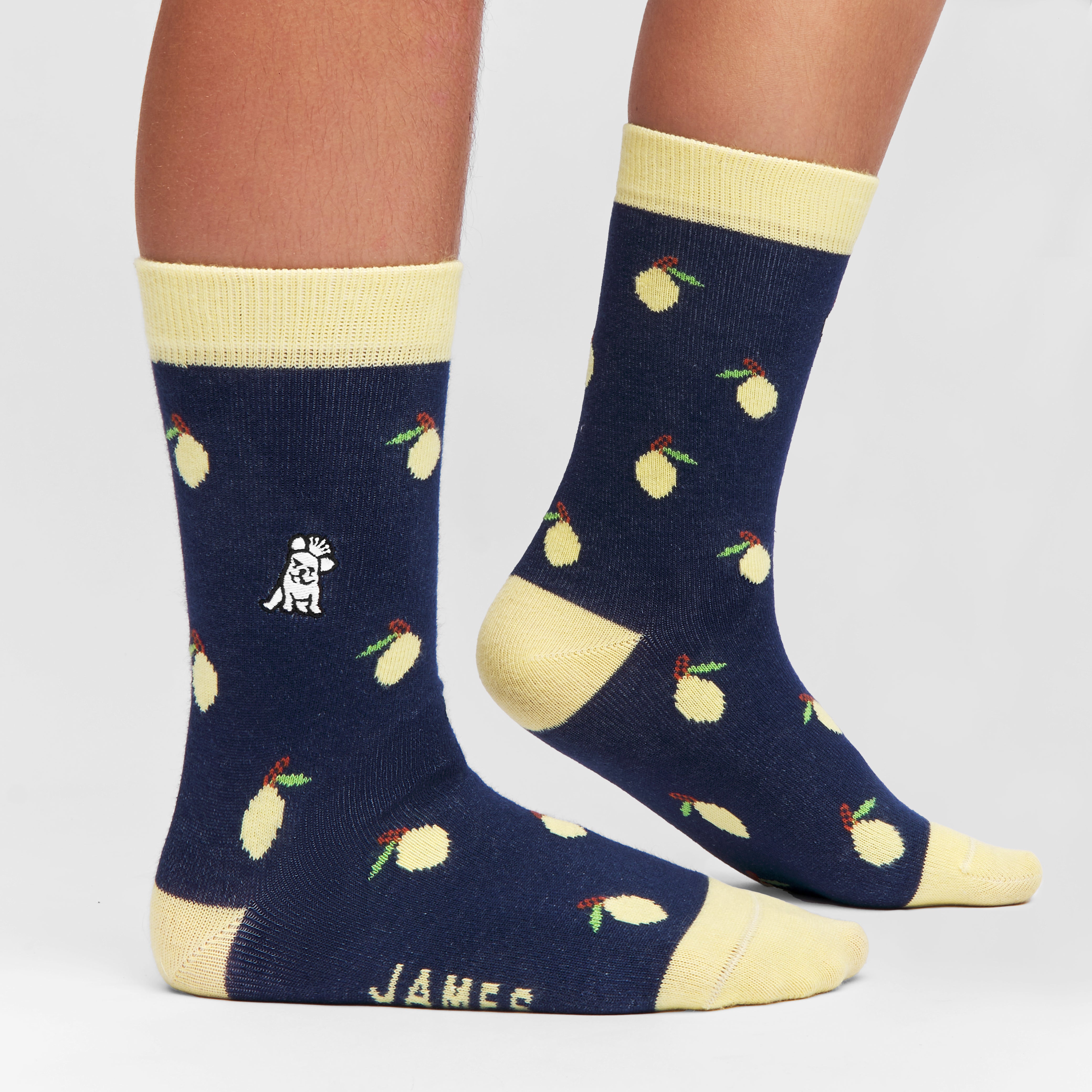 Close-up of the navy socks with lemon pattern, worn to showcase the design and fit.