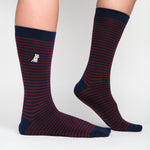 Pair of navy blue socks with red stripes, featuring an embroidered logo on the side.