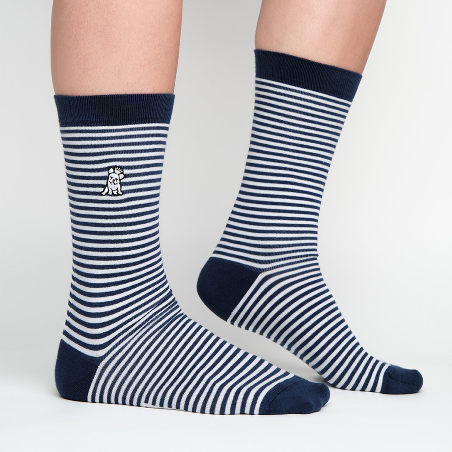 Pair of navy blue socks with white horizontal stripes, featuring an embroidered logo on the side