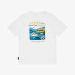 A white T-shirt featuring a central graphic print of a yacht on blue water with the text 'JAMES BARK Yacht Club ' and 'LUXURY BY THE COAST'.