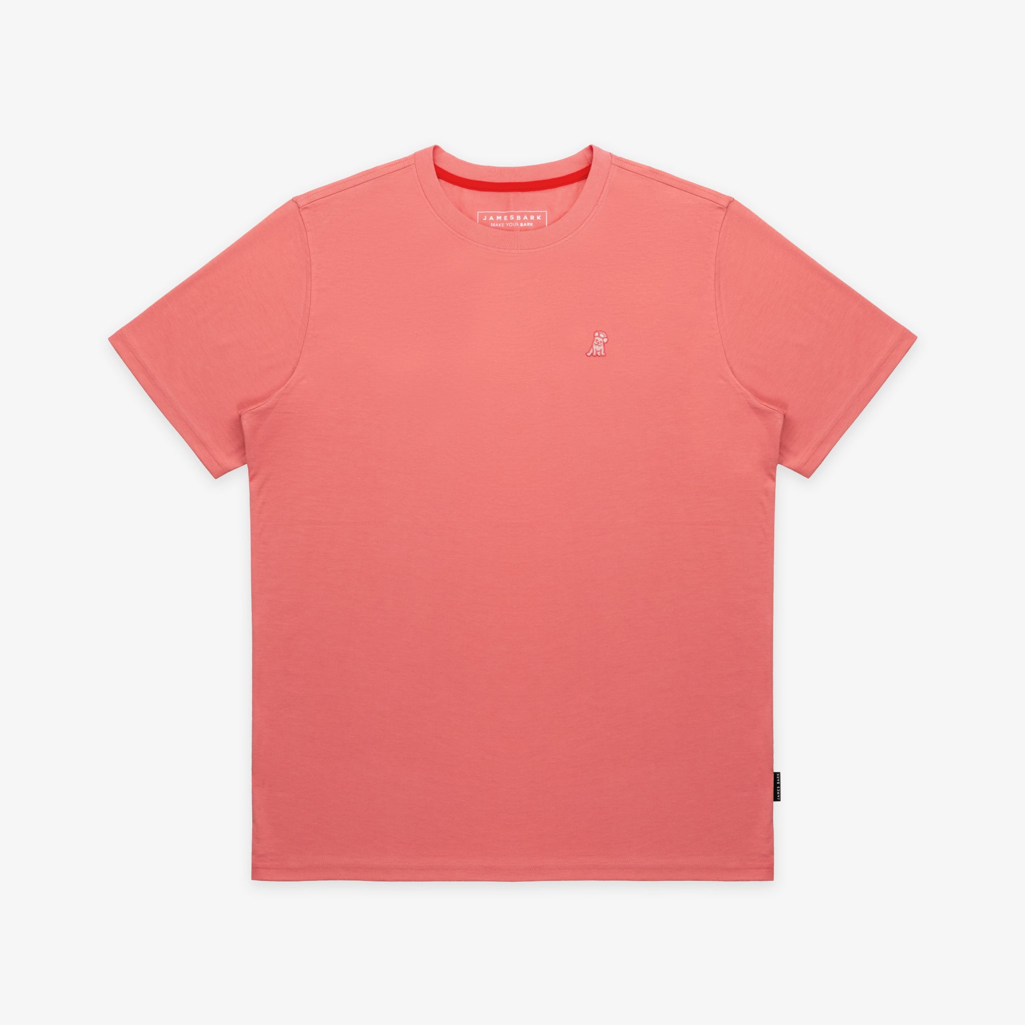 The salmon pink t-shirt laid flat, showing the front of the shirt with the small embroidered animal logo on the left chest.