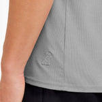 Gray sleeveless top with a logo on a person wearing it.