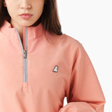 Close-up of a pink jacket featuring a zippered neck, highlighting the zipper detail and fabric texture. The jacket appears sleek and modern.