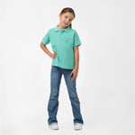 Full-body shot of the girl wearing the mint green polo shirt and blue jeans, standing with one hand on her hip and smiling.