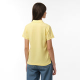 Rear view of the woman wearing the yellow polo shirt, showing the plain back design, paired with blue jeans.