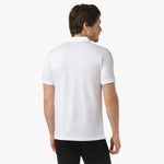 Back view of the white polo shirt being worn, showing the plain design without logos