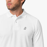 A close-up of the collar and button details of the white long-sleeved polo shirt, showing the inner label.