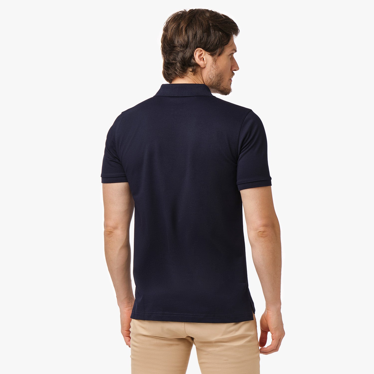 Back view of the navy blue polo shirt worn by a model, highlighting the plain back design.