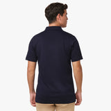 Back view of the navy blue polo shirt being worn, showing the plain back design.