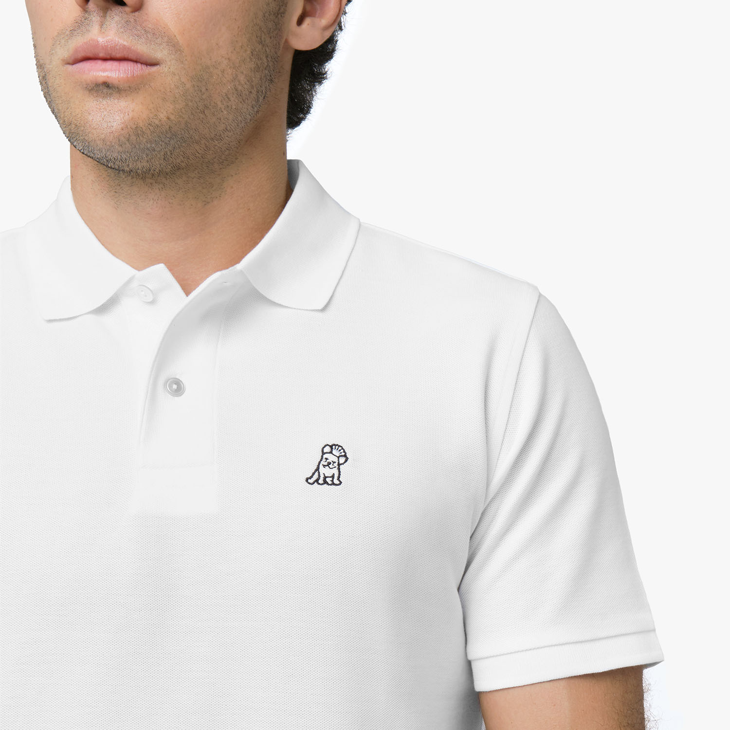 Close-up of a man wearing the white polo shirt, showing the collar and the small embroidered logo on the chest.