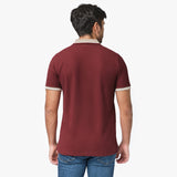 Back view of a man wearing the maroon polo shirt: The man is standing with his back to the camera, showing the back fit and design of the shirt, with beige accents on the collar and cuffs.