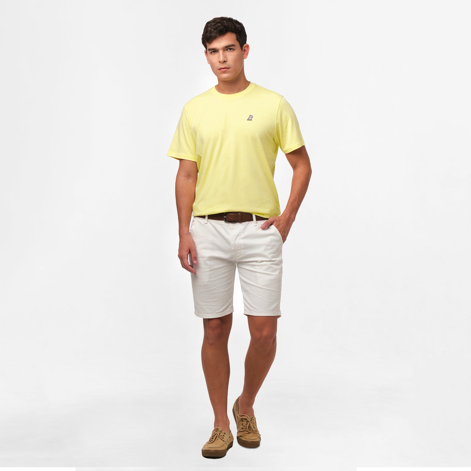 A full-body image of the man wearing the light yellow t-shirt and white shorts, standing in a relaxed posture.