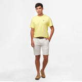 A full-body image of the man wearing the light yellow t-shirt and white shorts, standing in a relaxed posture.